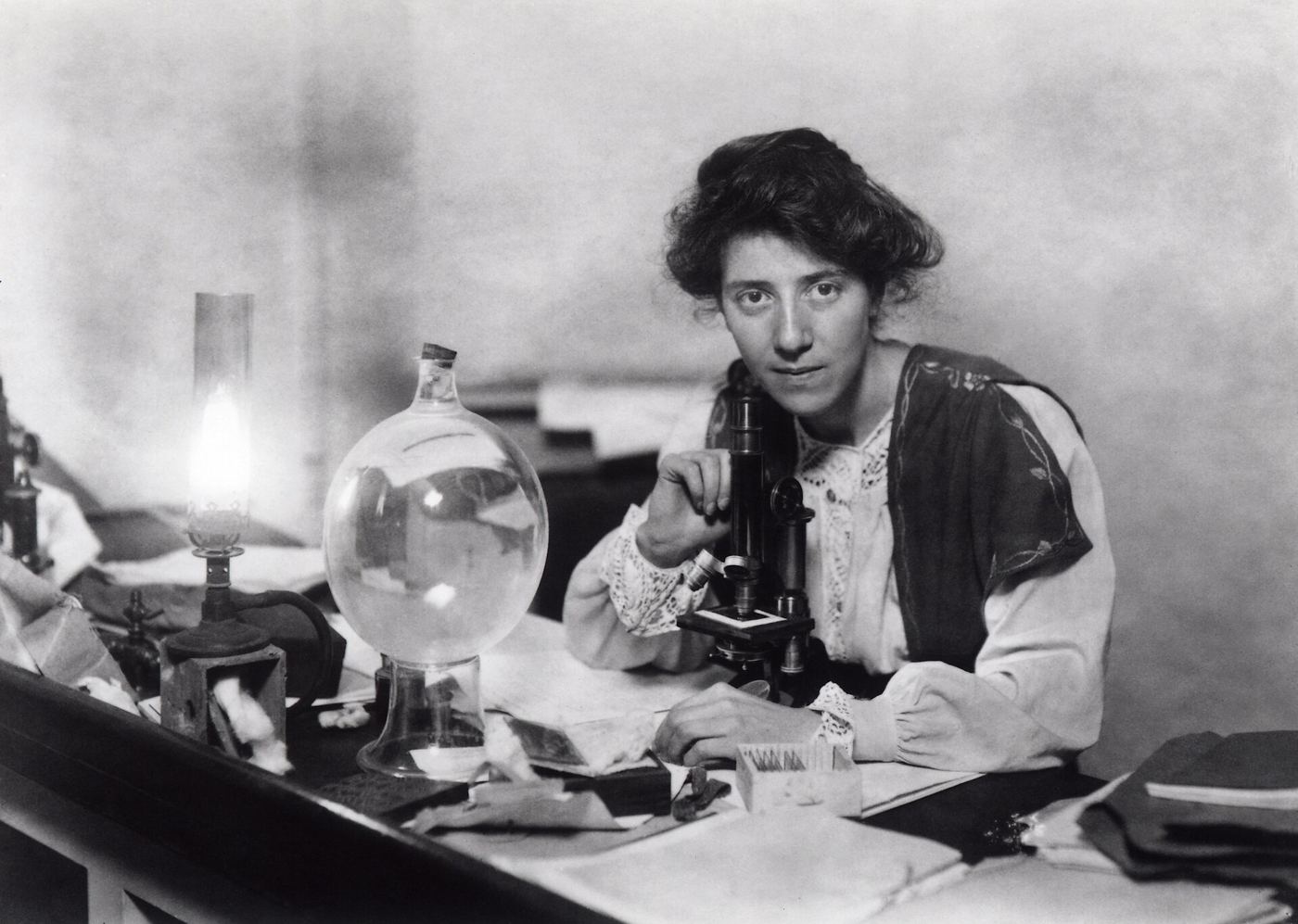 A scientist working with a microscope in a laboratory