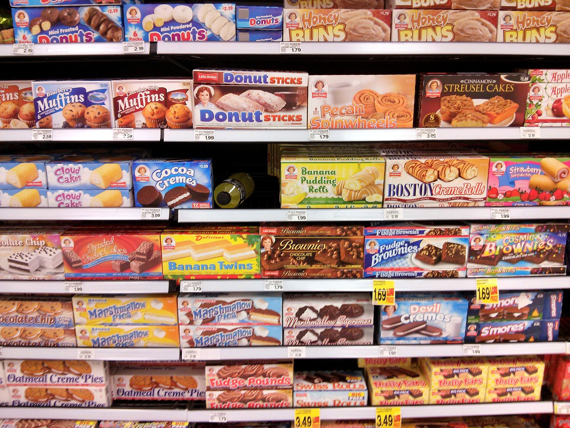 Packaged foods on a supermarket shelf with nutrition labels visible